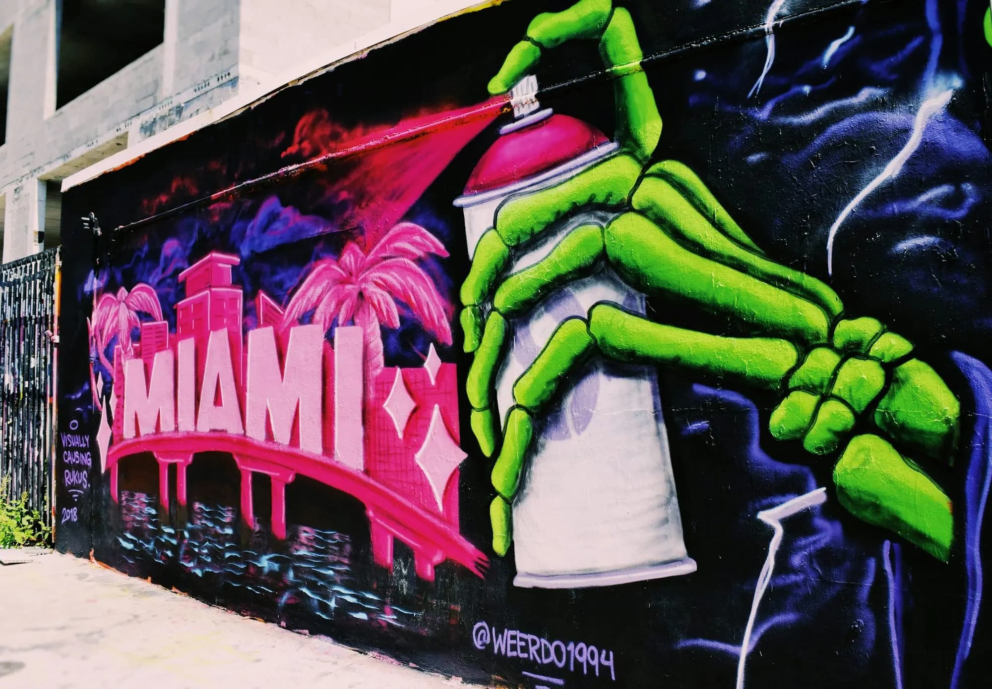A brightly colored mural on the theme of spray paint